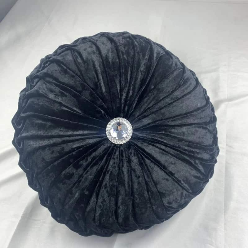 Coussin design rond noir avec diamant au centre