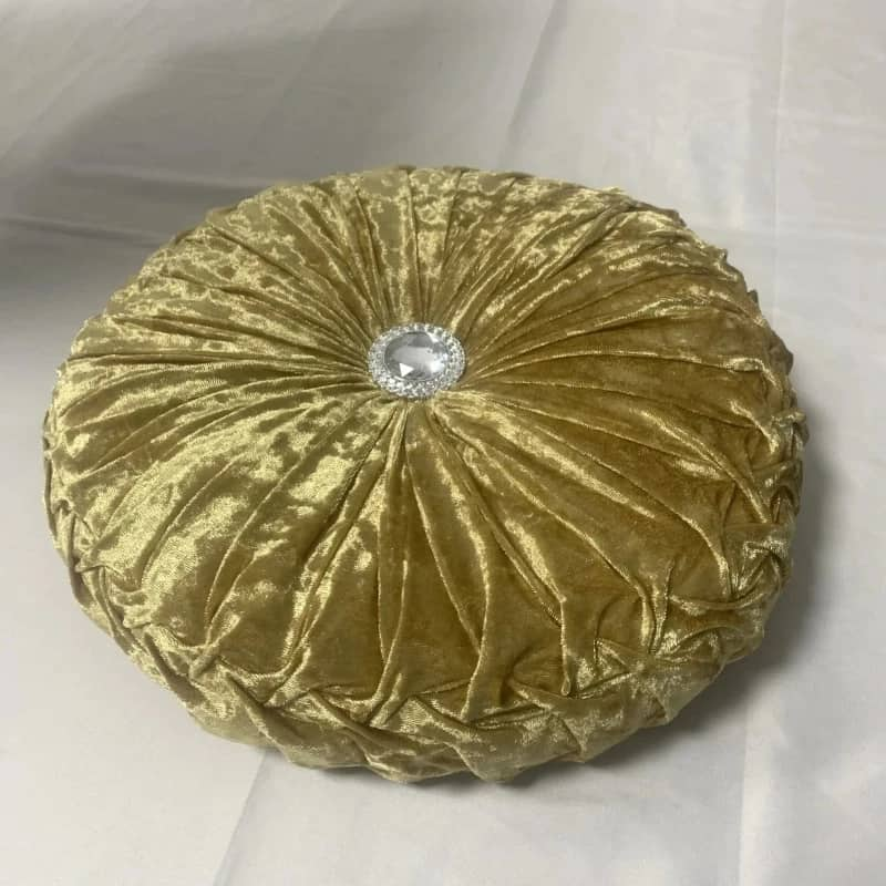 Coussin design rond doré avec diamant au centre